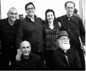 Archival black and white group portrait of the 1001 Nights Orchestra ensemble